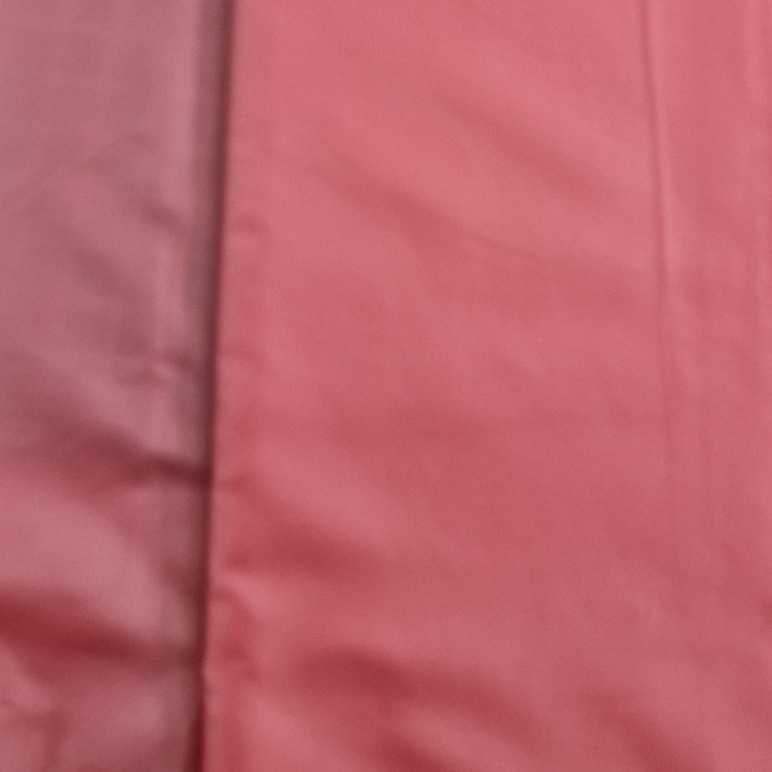 A close-up image of a pink polyester lining fabric showing its texture and slight sheen. Available at Eau Brink Studio