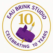 Eau Brink Studio logo celebrating 10 years with a purple ribbon and paintbrush.