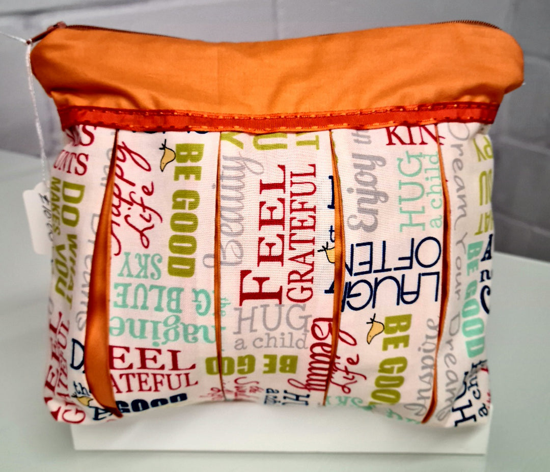 Feel Good Phrases on White with Orange Trim: Pleated Cosmetic Bag