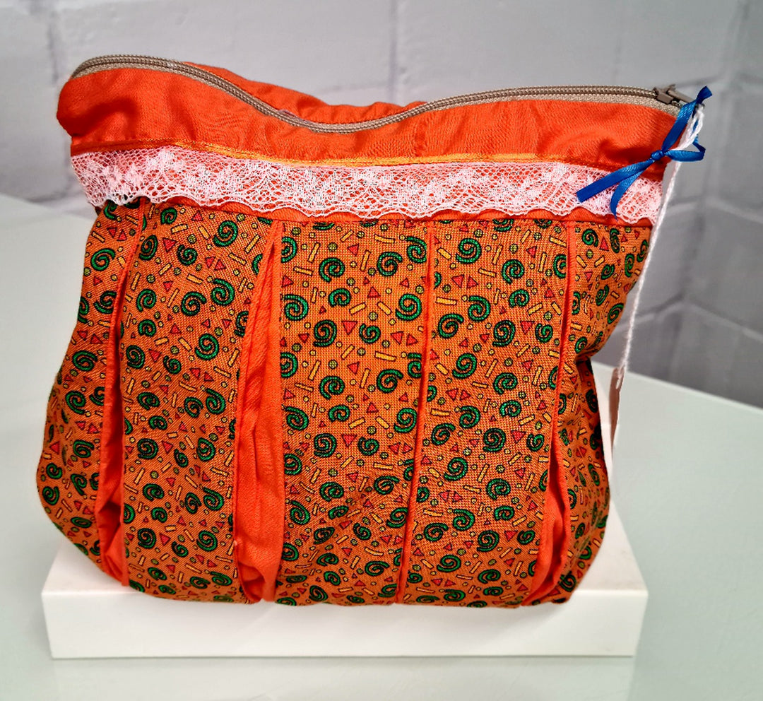 Pattern on Orange background: Pleated Cosmetic Bag